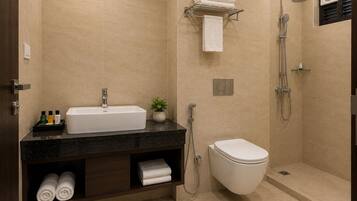 A modern bathroom with a sink, toilet, and shower.