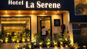 Hotel La Serene with illuminated windows and a well-lit entrance. - Hotel La Serene (Agra)