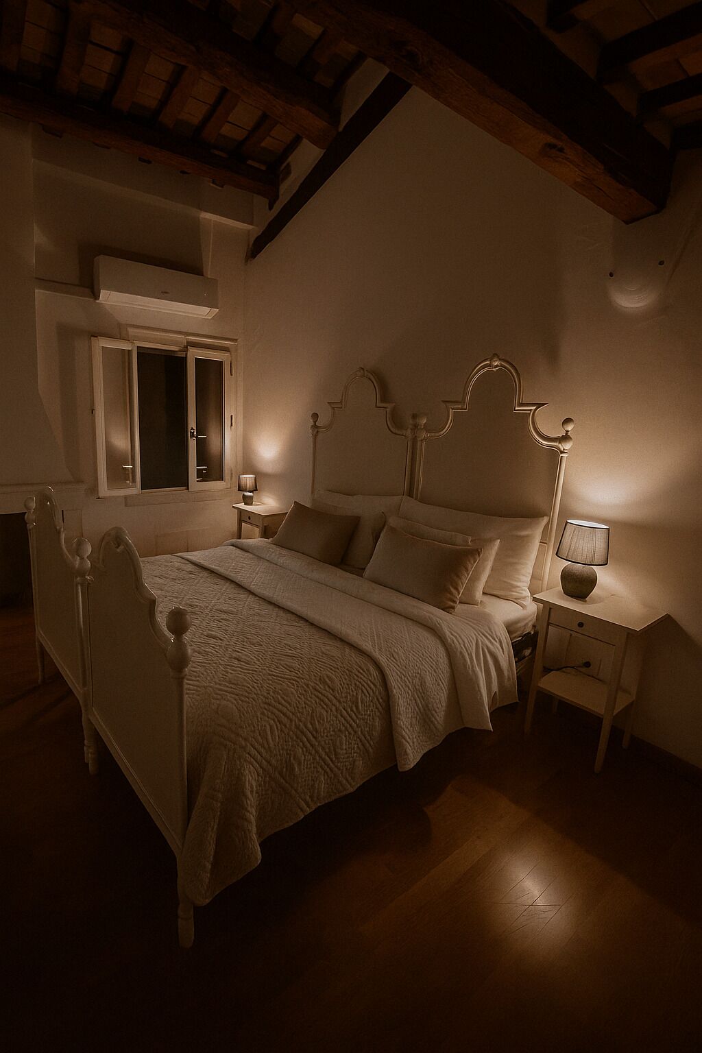 A bedroom with a wooden ceiling, a bed with a white headboard, two bedside tables with lamps, and a wardrobe with a mirror.