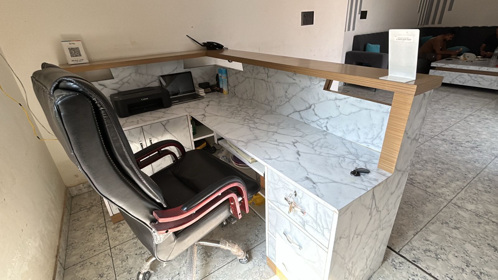 A home office setup with a desk, chair, and laptop.