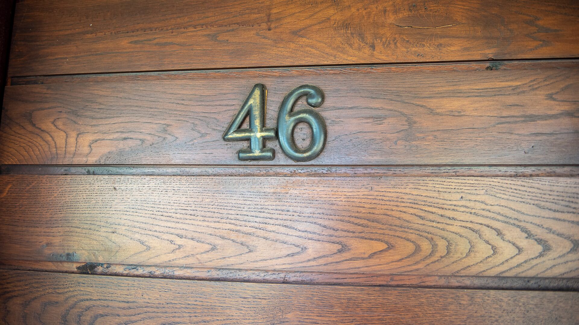 A wooden surface with the number 46 embossed on it.