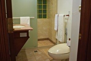 A bathroom with a sink, toilet, and shower area. - Sand Rose Suite Hotel (Al Khobar)