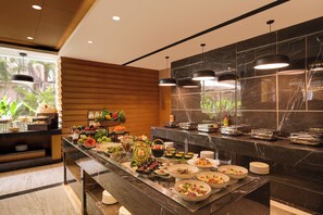 A buffet setup with various dishes and a modern interior design. - Lemon Tree Premier Navi Mumbai (Navi Mumbai)