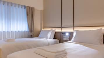 Habitación Deluxe con 2 camas individuales | Caja fuerte, escritorio, wifi gratis y ropa de cama