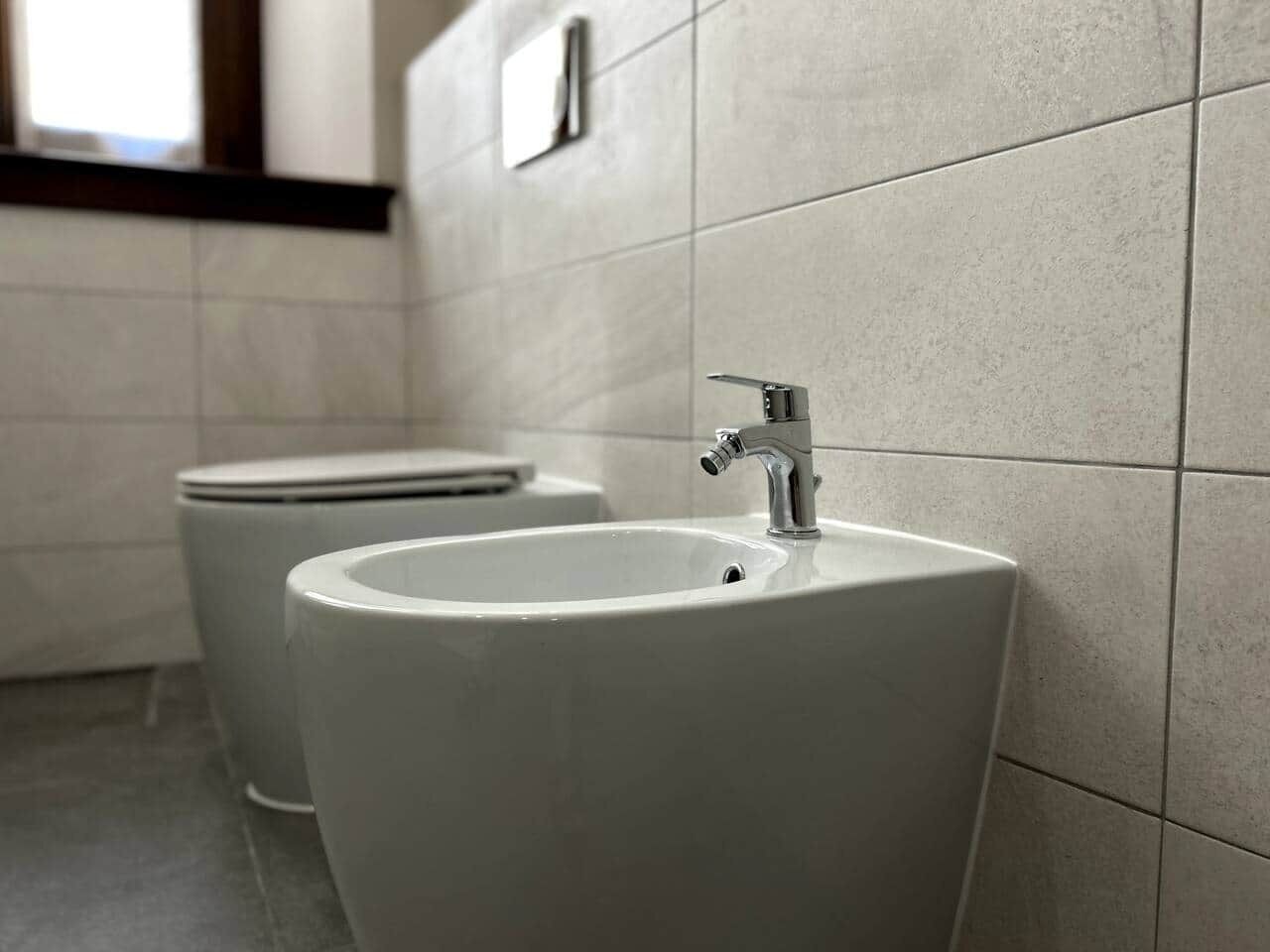 A restroom with two sinks and a toilet.