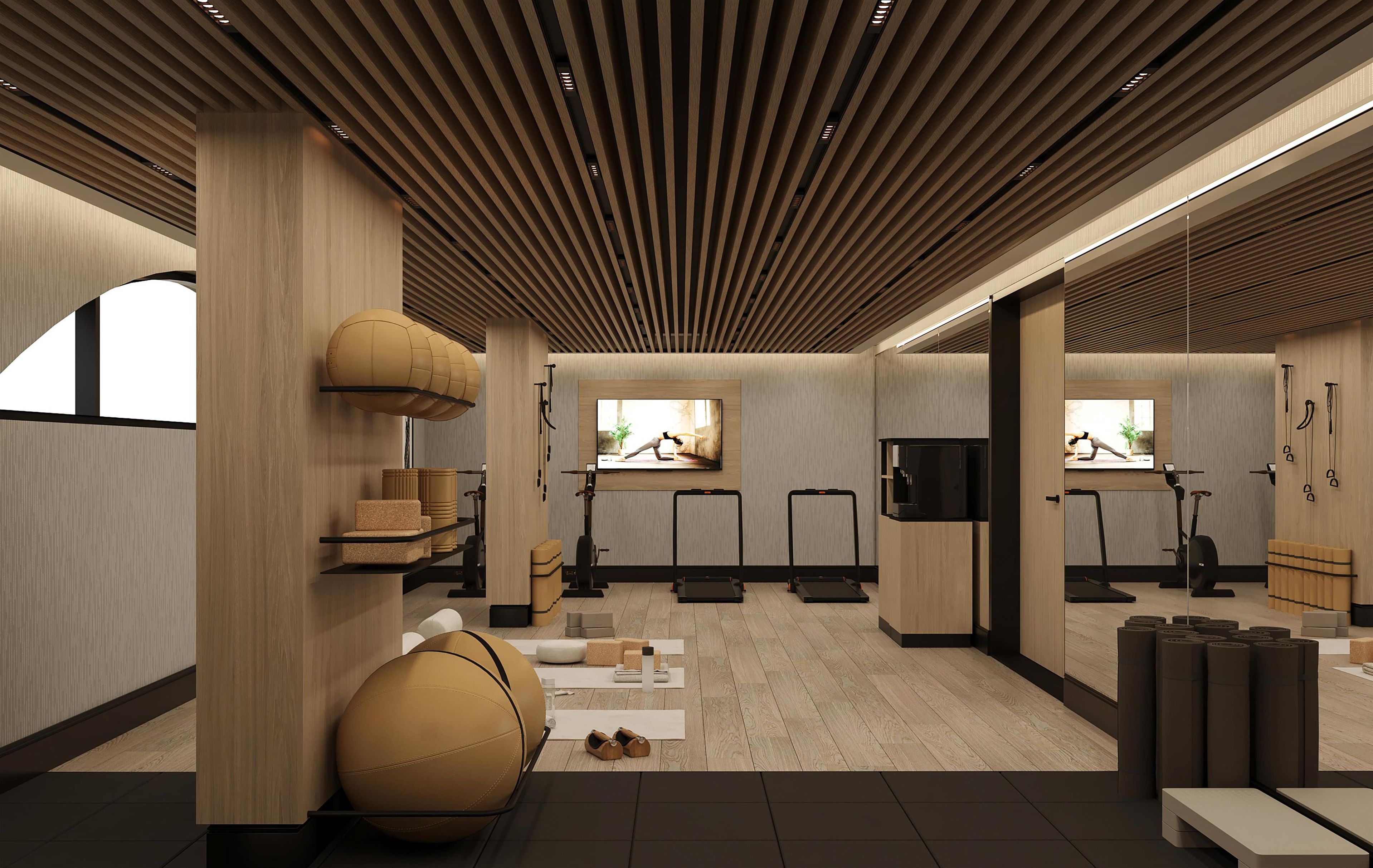 Un gimnasio moderno con equipo de ejercicio, un espejo grande y techo de madera.