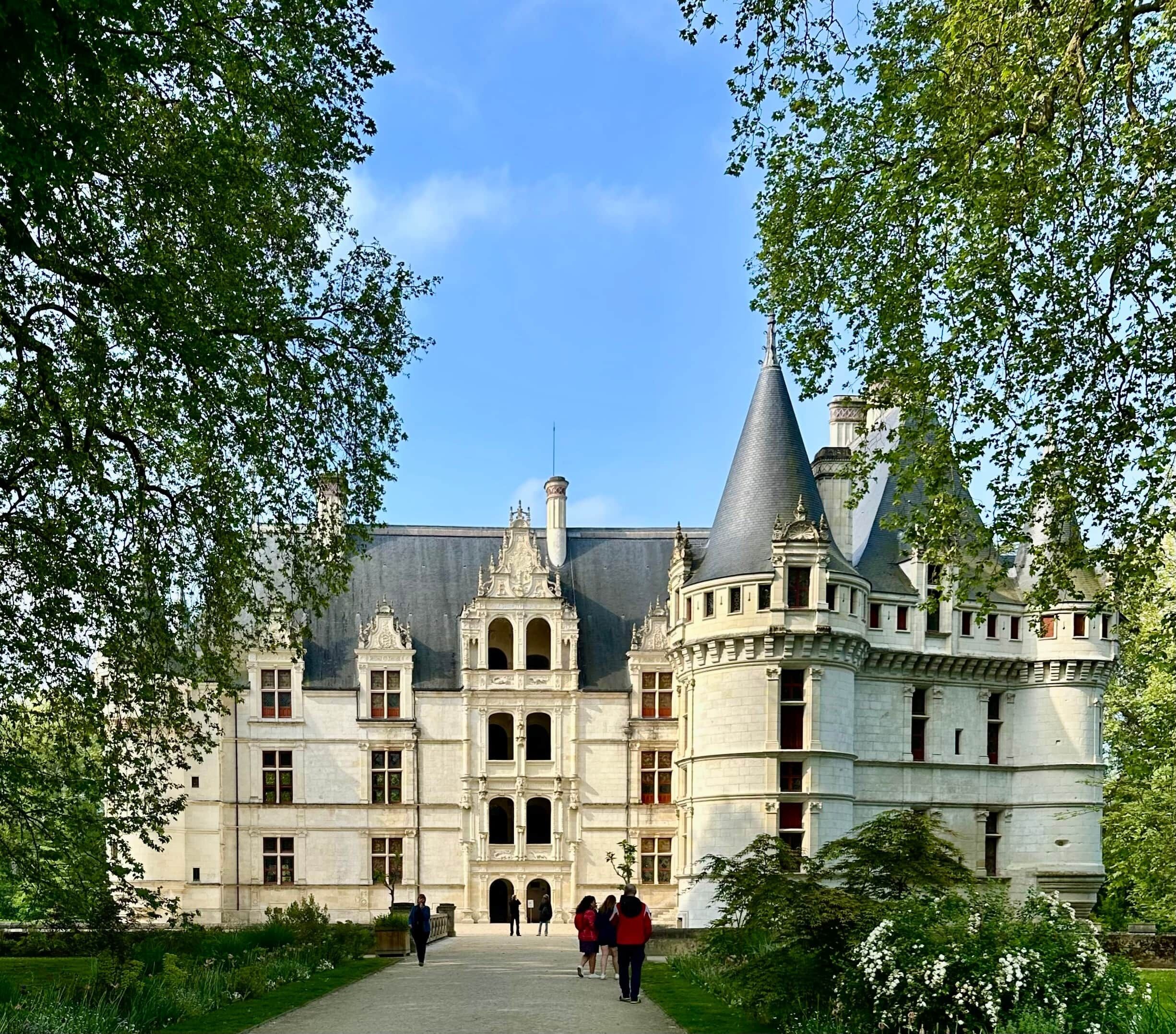 A grand historic building with a central courtyard, ornate architectural details, and a prominent tower.