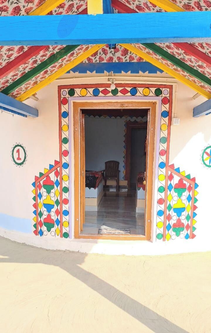 A colorful building entrance with a door, a number '1' sign, and a patterned wall.