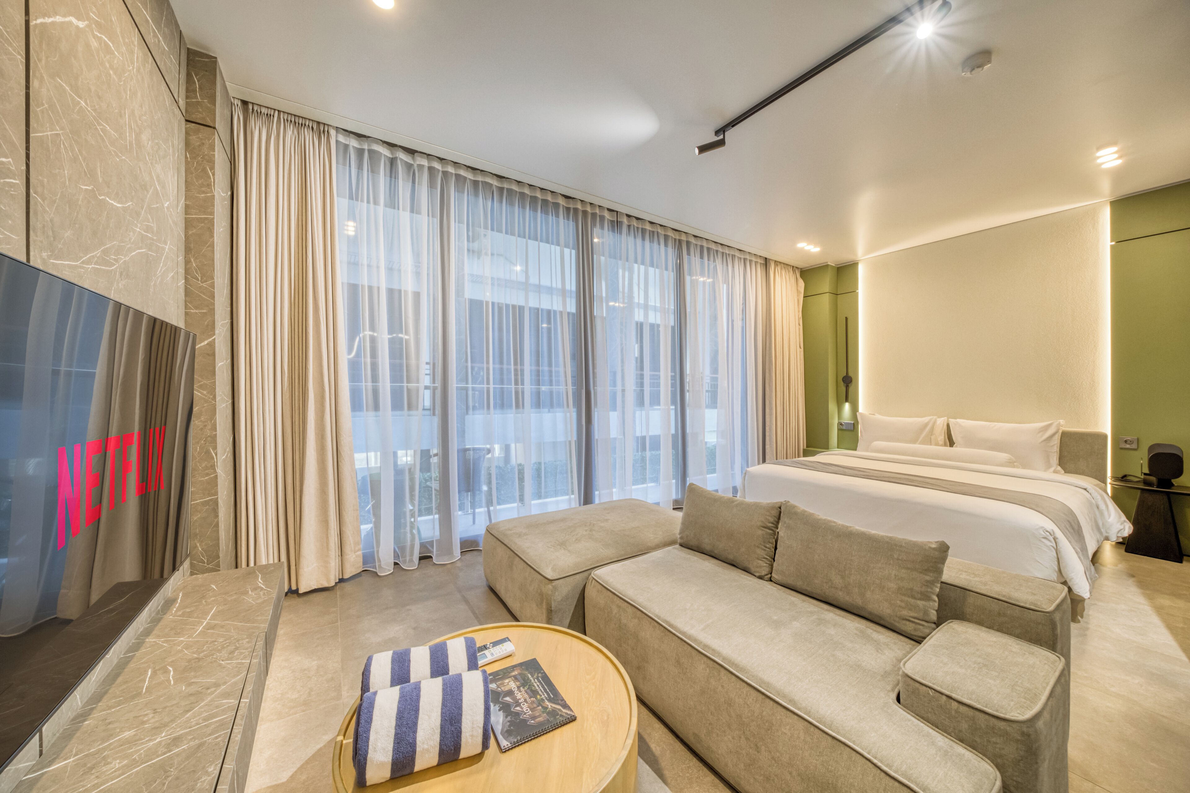 Deluxe Room, Balcony, City View | Living area | 55-inch flat-screen TV with digital channels