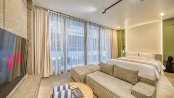 Deluxe Room, Balcony, City View | Living area | 55-inch flat-screen TV with digital channels