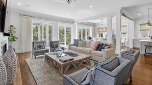 A spacious living room with a fireplace, a large coffee table, and comfortable seating.