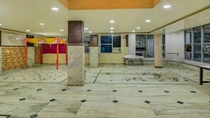 A spacious hall with a high ceiling, marble flooring, and a central pillar. - Hotel Shri Laxmi Palace (Kanpur)
