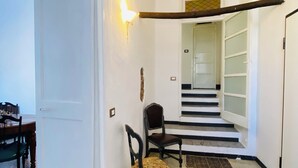 A staircase with black and white steps leading to a door with frosted glass panels. - Dwelling Concept_Art and holiday home_Free parking (Finale Ligure)