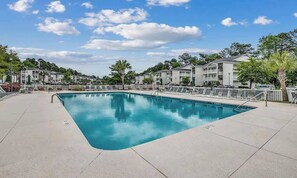 A rectangular pool with a clear blue water surface, surrounded by a white fence and lounge chairs. - Bright 2BR Condo near Beach & Golf , River Oaks (Myrtle Beach)
