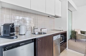 Fridge, stovetop, dishwasher, coffee/tea maker