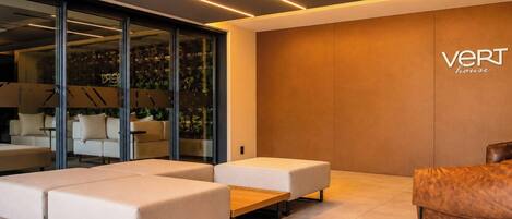 A modern interior with a sofa set, a wooden coffee table, and a leather armchair.