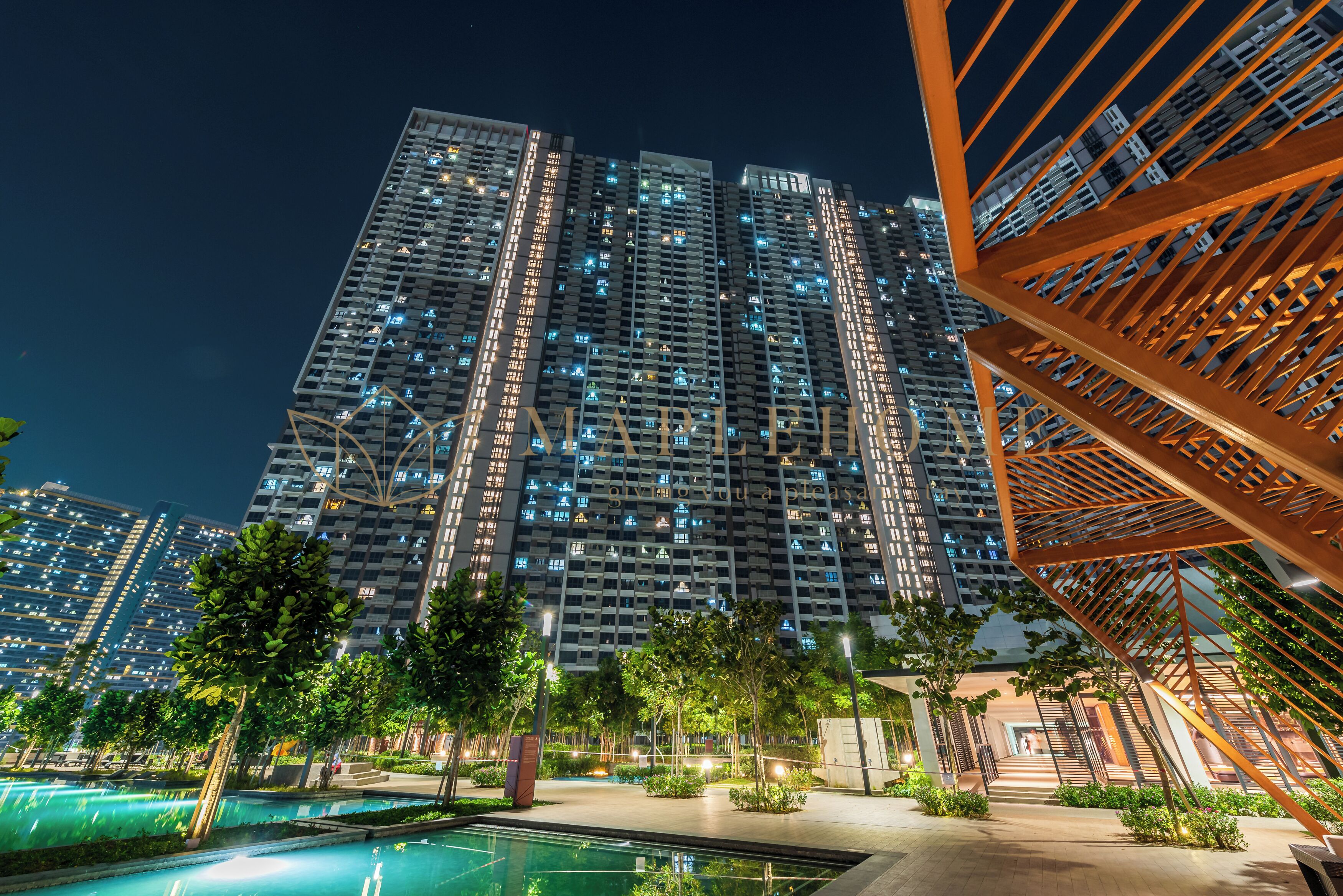 A high-rise building with multiple balconies, a swimming pool, and a modern staircase structure.