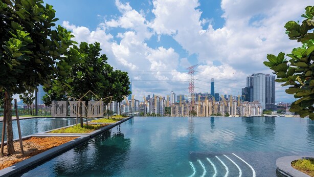 A swimming pool with a city skyline in the background.