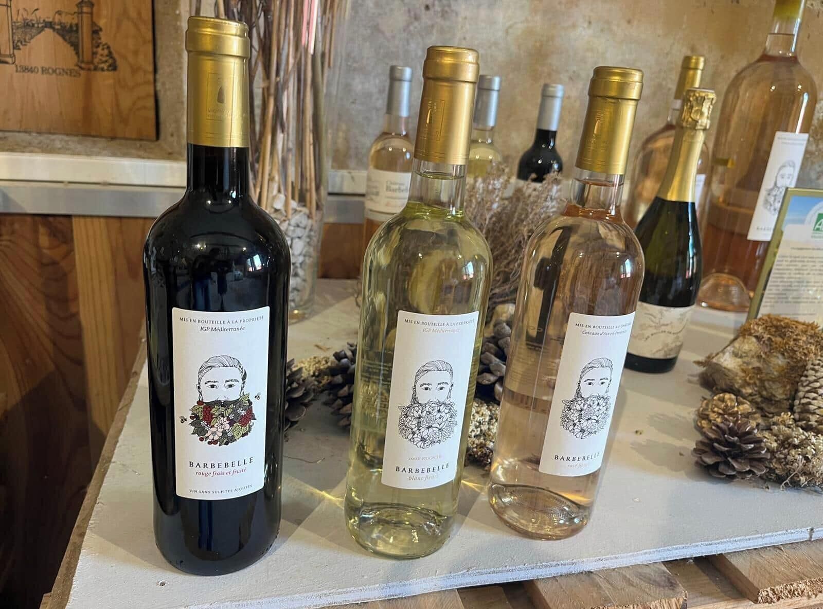 A selection of wine bottles on a counter with labels and illustrations.