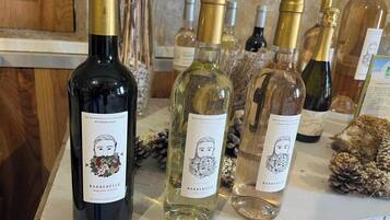 A selection of wine bottles on a counter with labels and illustrations.