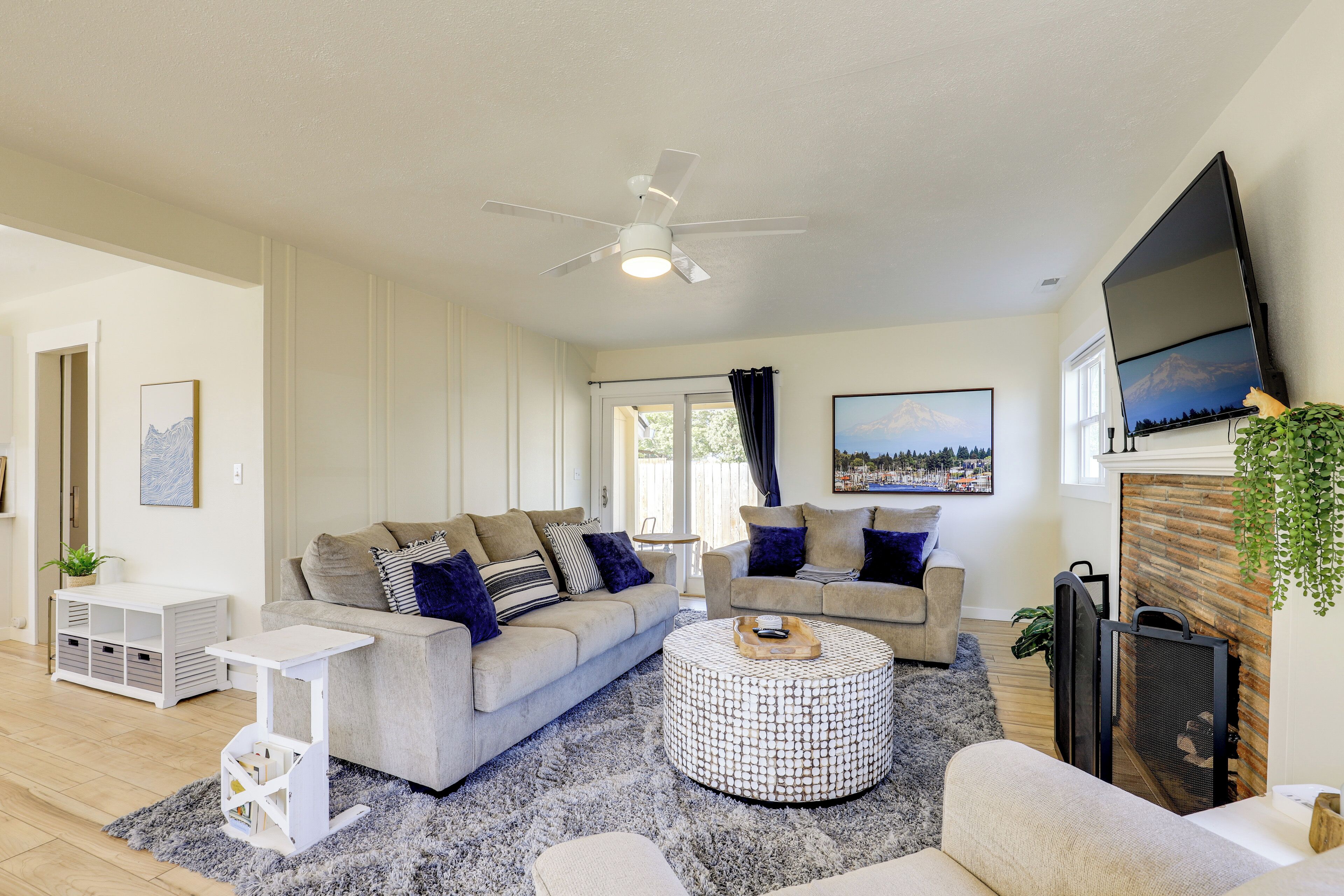 A modern living room with a sofa, coffee table, and TV.