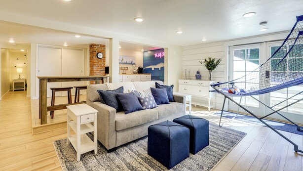 A modern living room with a sofa, ottomans, a coffee table, and a hammock. - Walk to Dtwn Camas! Updated Home w/ Game Room (Camas)