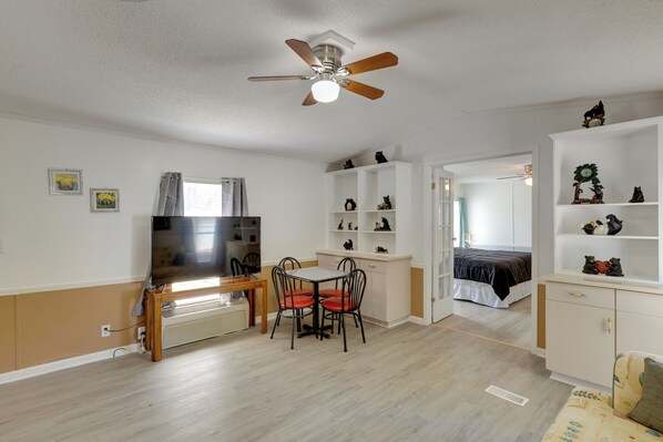 A compact living space with a dining area, kitchenette, and a bedroom. - Fish & Explore: Wooded Lake Guntersville Retreat (Langston)