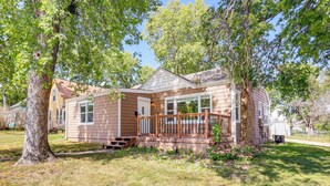 A two-story house with a wooden deck and a brick chimney. - Half-mi to Dtwn Yankton & River: Charming Home! (Yankton)