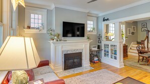 A living room with a fireplace, television, and seating area.