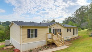 A two-story mobile home with a front porch and a small staircase. - Deck w/ Mtn Views: Family-friendly Asheville Home! (Asheville)