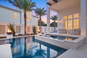 A modern pool area with a checkered border, palm trees, and outdoor seating. - 10,000+ Sq Ft Estate w/ Beach Access, Gulf Views, Pool, Pickleball, Bar (Inlet Beach)