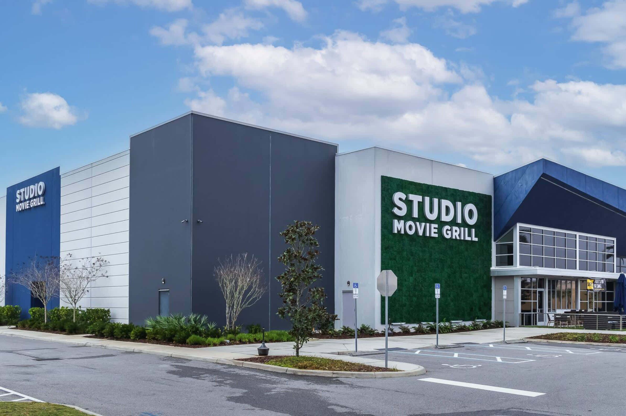 Un edificio moderno con un letrero que dice "STUDIO MOVIE GRILL".