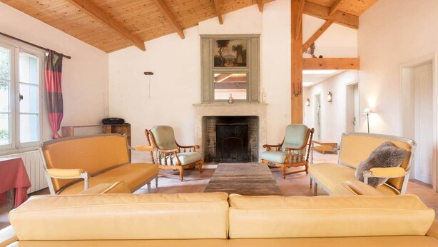 A cozy living room with a fireplace, wooden beams, and two armchairs. - Marais Aixois-Villa-Villa-Ensuite Bathroom-View of the (Île-d'Aix)