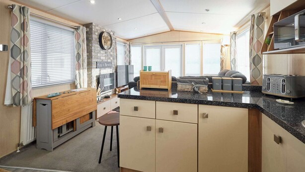 A compact kitchen with a central island, a built-in stove, and a refrigerator. - Host & Stay | Leon's Retreat (Cresswell)