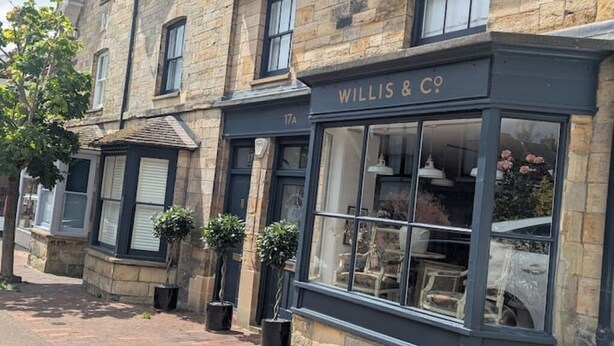 A building with a storefront labeled "WILLIS & CO." and a number "17A" above the entrance.
