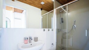 A bathroom with a white sink, toilet, and glass-enclosed shower. - Duomo Studio Room with Private Bath and Kitchenette (Firenze)