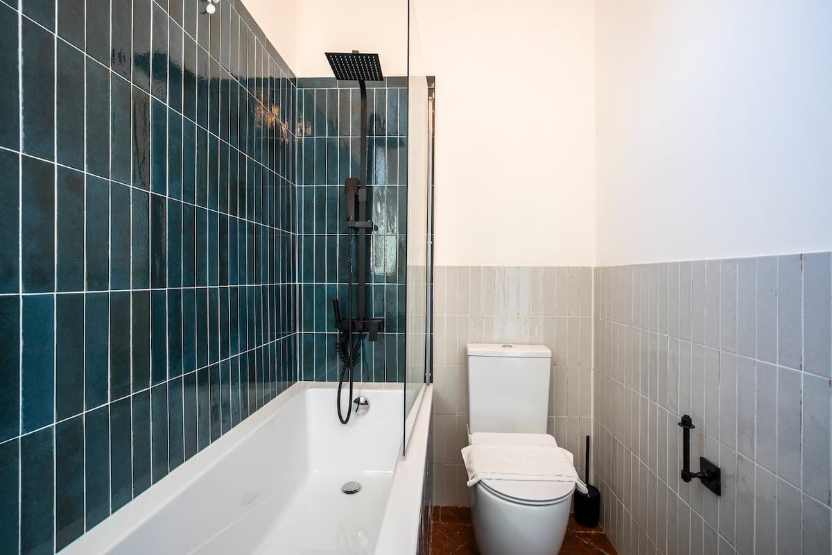 A bathroom with a bathtub, a shower, and a toilet.