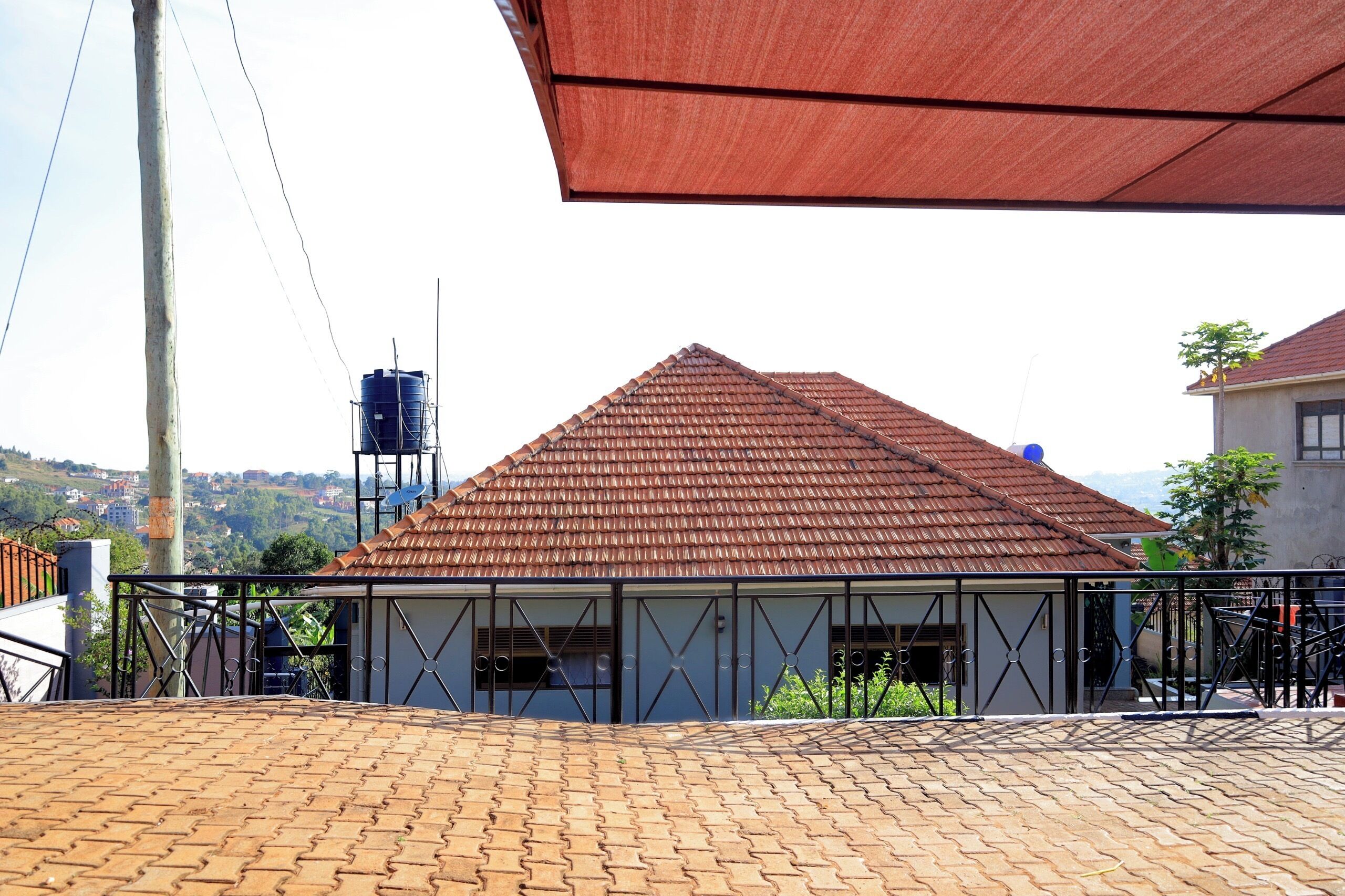 A building with a tiled roof and a metal fence.