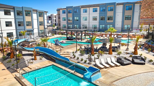 A resort with multiple swimming pools, a water slide, and outdoor seating areas. - Mane Stay At Terra 3 Bedroom Condo (Hurricane)