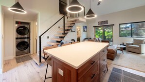 A modern kitchen with a central island, built-in appliances, and pendant lighting. - Stylish 4BR Canyons Village-Walk to Cabriolet-Hidden Creek 37D (Park City)