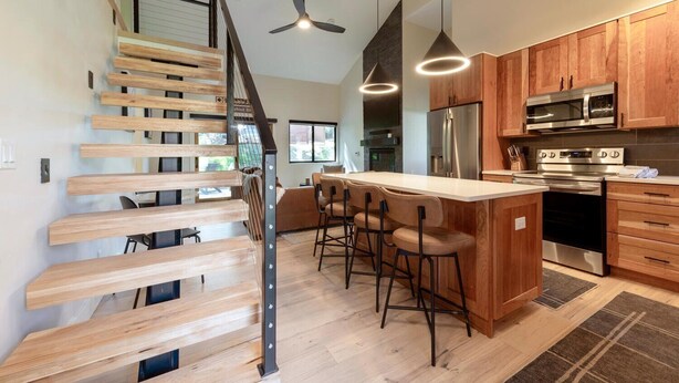 A modern kitchen with wooden cabinets, a stainless steel refrigerator, and a built-in oven. - Stylish 4BR Canyons Village-Walk to Cabriolet-Hidden Creek 37D (Park City)