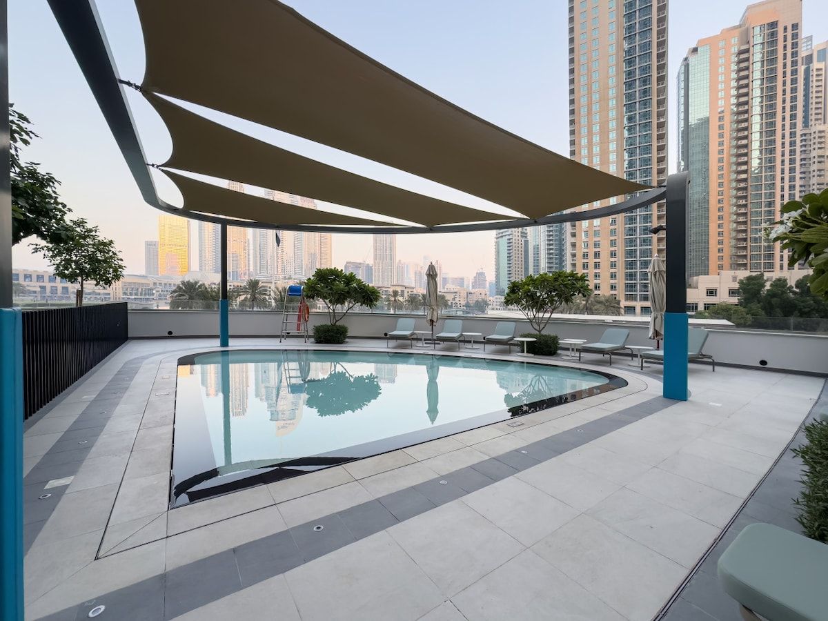 Ein Pool auf dem Dach mit Blick auf hohe Gebäude.