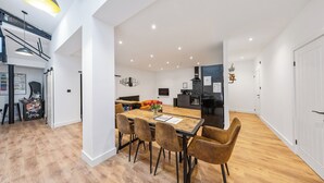 A modern kitchen with a central island, wooden flooring, and recessed lighting. - ELEVATED ESCAPE - 3 bedroom house with rooftop terrace,sauna,hot tub&cinema room (Hythe)