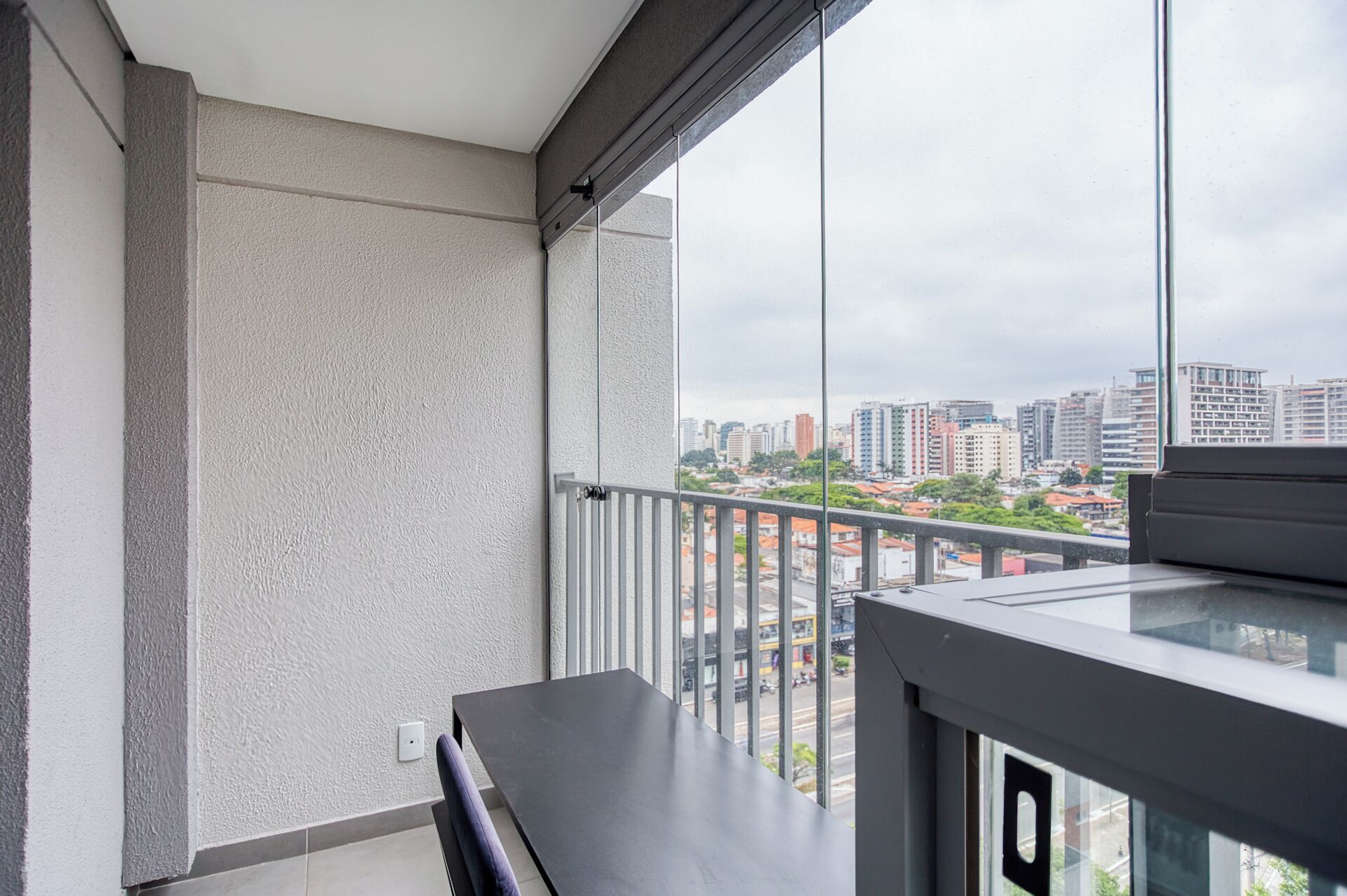A balcony with a view of a cityscape.