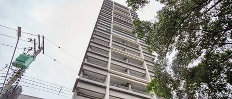 A multi-story building with a modern architectural design, featuring balconies on each floor.