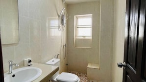 A bathroom with a toilet, sink, and shower. - The Rabbit Hole Hotel Sok San (Siem Reap)