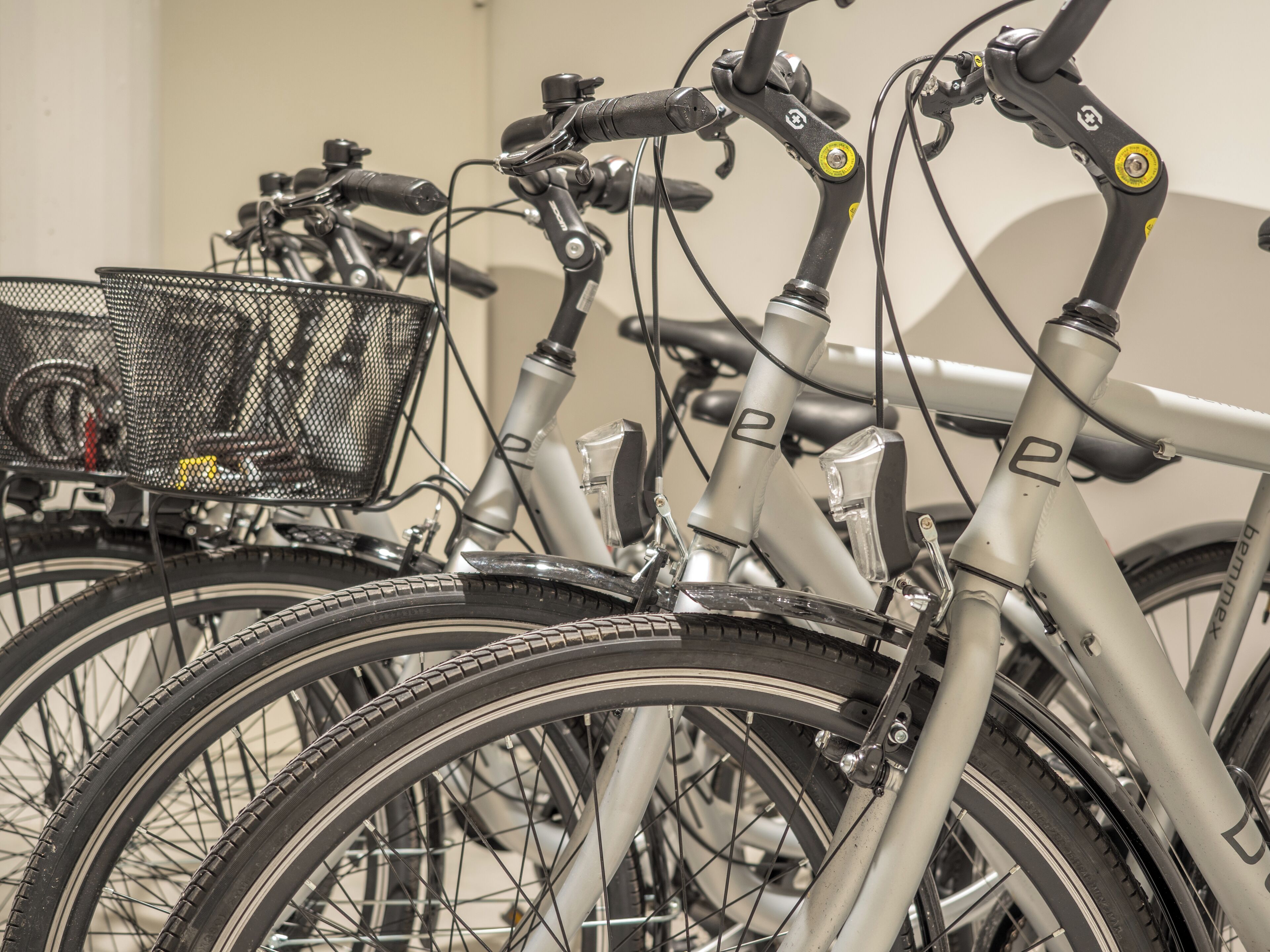 A row of bicycles with baskets, handlebars, and frames.