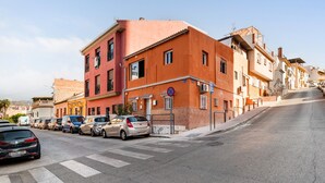 A street with parked cars and buildings.