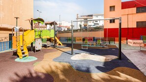 A playground with climbing structures and a swing set.