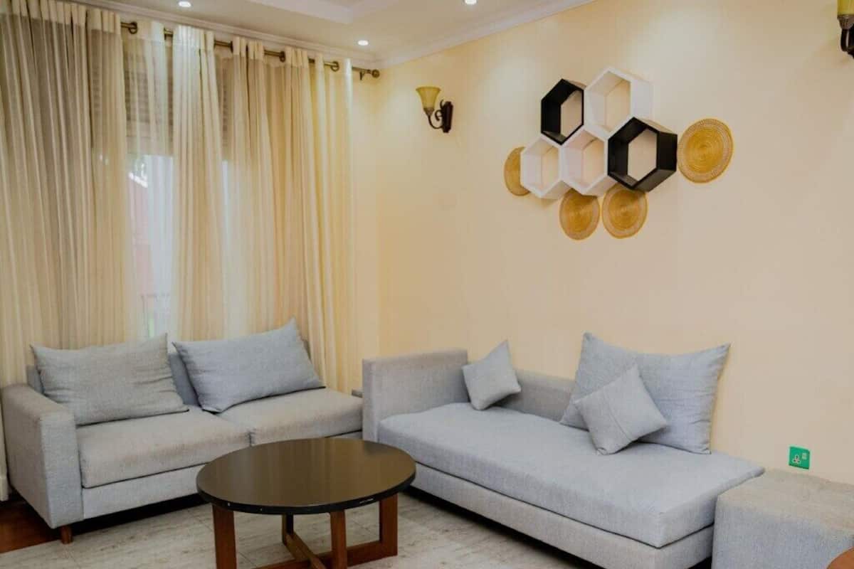 A living room with two sofas, a coffee table, and decorative wall art.